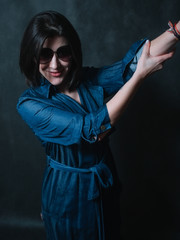 Beautiful brunete women portrait in sunglasses on dark background