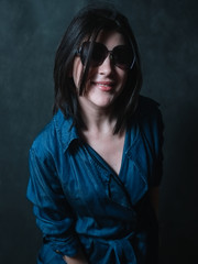 Beautiful brunete women portrait in sunglasses on dark background