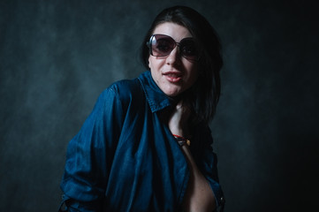 Beautiful brunete women portrait in sunglasses on dark background