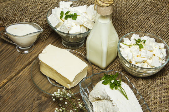 Dairy products on a wooden background and burlap, top view
