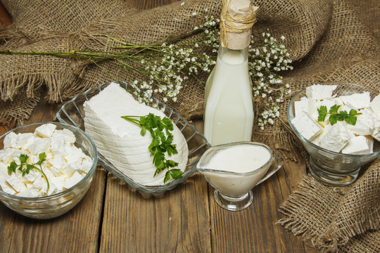 Dairy products on a wooden background and burlap, top view