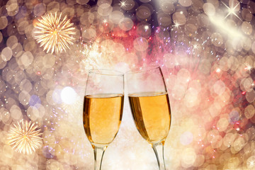 Champagne glasses on sparkling background