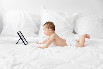 Baby lying on tummy facing a mirror