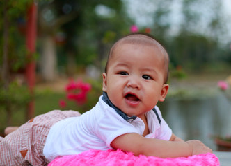 Outdoor portrait of a cute 6 months old Asian baby boy