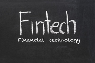 Fototapeta premium fintech word subject on black chalkboard