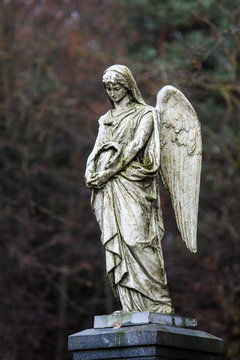 Statue of mourning angel in some lithuanian cemetery