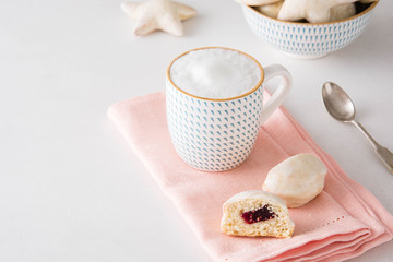 Cookies with jam and a cup of milk.