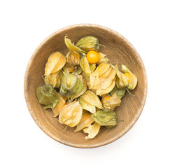 Physalis berries in a wooden bowl isolated on white background top view.
