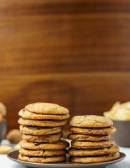 freshly baked chocolate chip cookies on a table with blurred background.