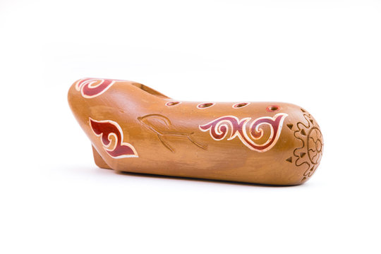 Kazakh traditional sazsyrnai. 
Closeup of a sazsyrnay - kazakh traditional ocarina isolated on white background