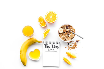Morning habits of successful people. Healthy breakfast porridge with fruits and planning the day. White background top view