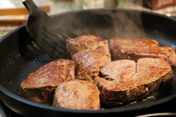 Beef fillet (beef tenderloin) grilling in the frying pan