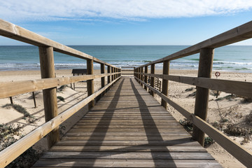 Fototapeta na wymiar wooden bridge to access the beach