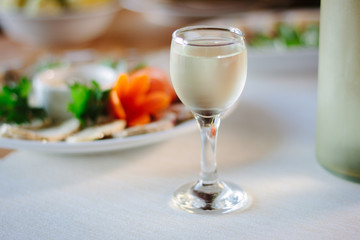 Russian vodka in glass on holiday table.