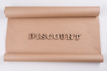 A Word DISCOUNT abstract wooden letters, background vintage kraft paper
