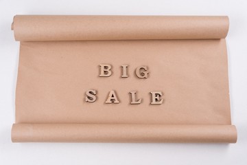 A Word BIG SALE abstract wooden letters, background vintage kraft paper
