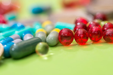 many different pills isolated on green background