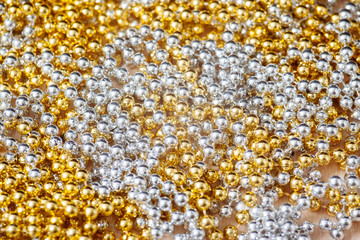 Silver and gold beads. Texture, background.