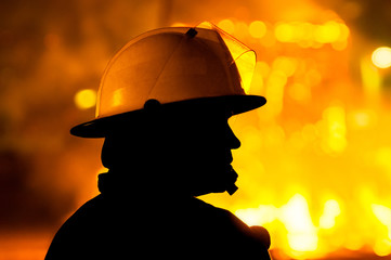 Fototapeta premium firefighter in action , silhouette
