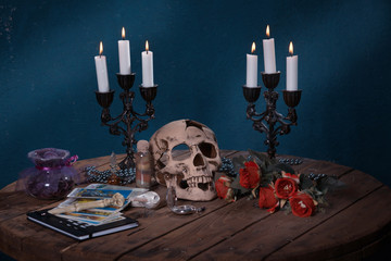 Fototapeta premium Mystic still life with skull, tarot cards, books and candles