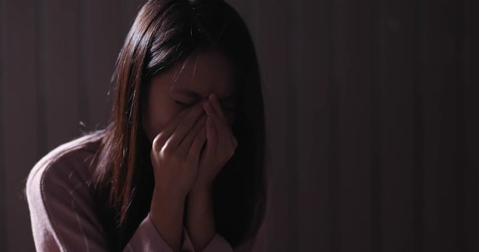 Woman feeling sad in the dark