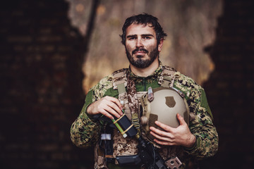 soldier with rifle in full gear. Military man on the background of nature.