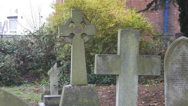 Old stone crosses on graves. City cemetery.