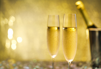 Cold champagne glasses on gold background.Selective focus.