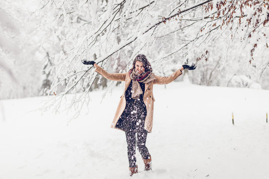 beautiful young woman enjoying her afternoon or morning outdoors in beautiful snowy nature in winter 