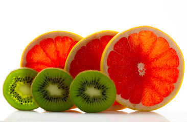 Fresh ripe juicy and appetizing grapefruit with kiwi and their parts close-up, isolated on white...