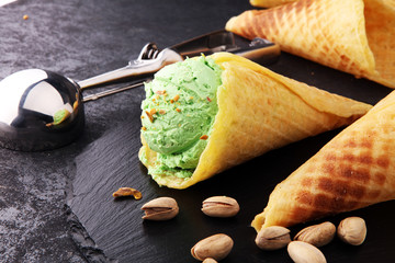 scoop of pistachio ice cream with pistachios on wooden background