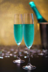 Still life  with   blue champagne and gold bokeh background/Selective focus.