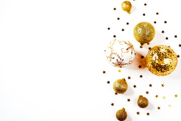 Christmas composition. a pattern of golden christmas balls and stars from above. Flat lay, top view
