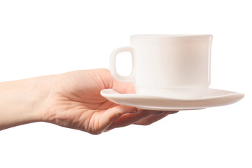 White cup and saucer in female hands isolated
