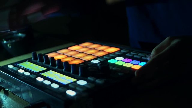 dj starts playing music set in the club playing the drum machine