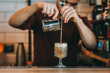 Fototapeta na wymiar Expert barman is making cocktail