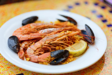 Paella. Rice with king prawns, mussels and lemon