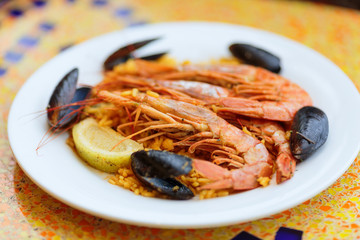 Paella. Rice with king prawns, mussels and lemon