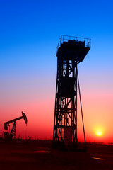 Tower mounted pumping unit under the sunset, close-up