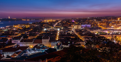 Spectacular night view of Lisbon, Portugal overseeing the entire downtown, the Tagus river, the Cristo Rei - Sanctuary of Christ the King - and the Ponte 25 de Abril suspension bridge 