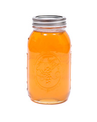 Organic amish honey in glass jar isolated on white background