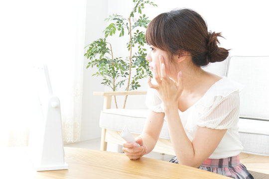 Young woman taking care of face