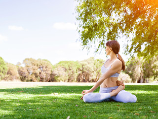 Young woman practicing yoga in the park