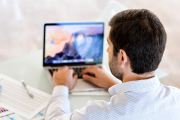 Fototapeta premium Handsome businessman working at computer