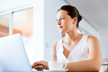 Young beautiful woman working on her laptop