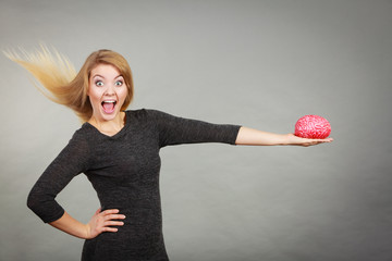 Woman holding brain having idea