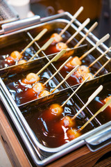 Mitarashi dango ball on skewer with sauce