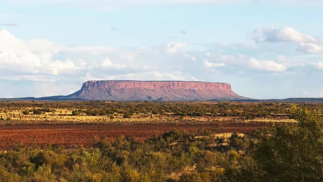 a panning shot of mount conner in australia's northern territory at sunset