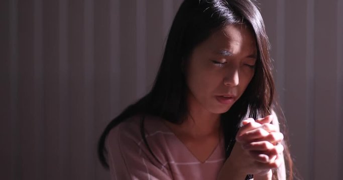 Christian women praying in the dark