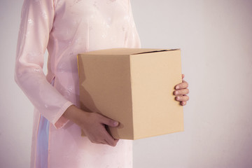 beautiful woman in pink dress and vietnam hat holding box